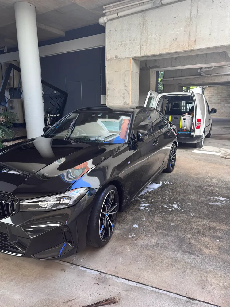 Black BMW 3 Series M Sport detailed to a deep gloss under cover